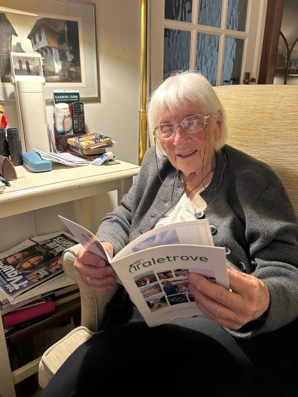 Grandparent reading a Taletrove newsletter