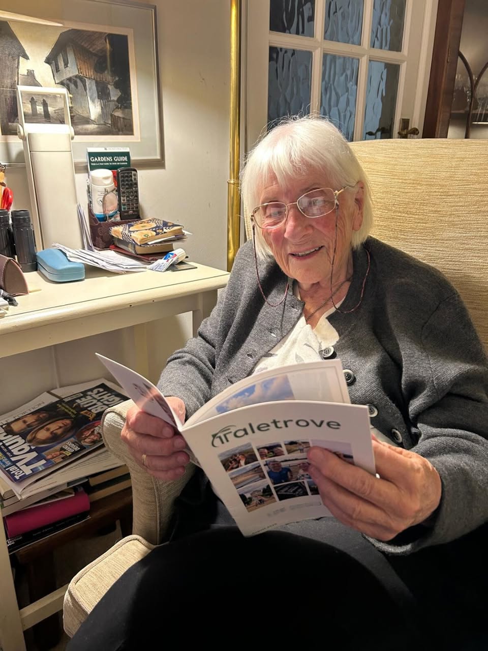 Grandparent reading a Taletrove newsletter